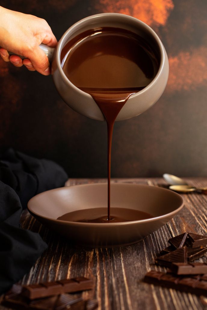 Vegan chocolate ganache being pour into a bowl