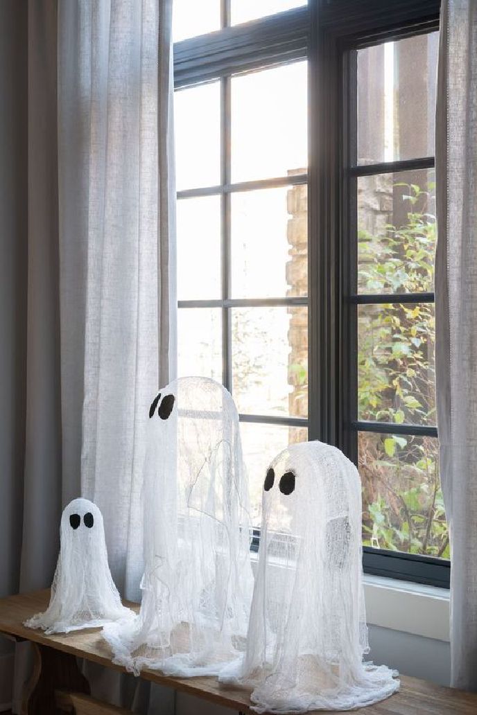 Cheesecloth ghosts on a window ledge