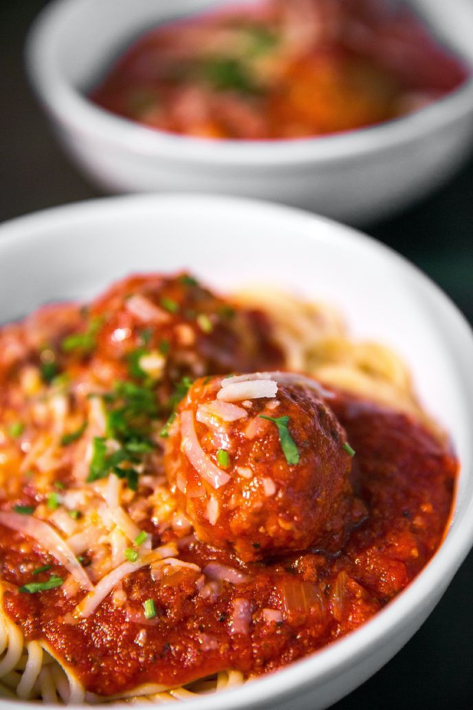 Gluten free meatballs in a bowl with pasta and sauce