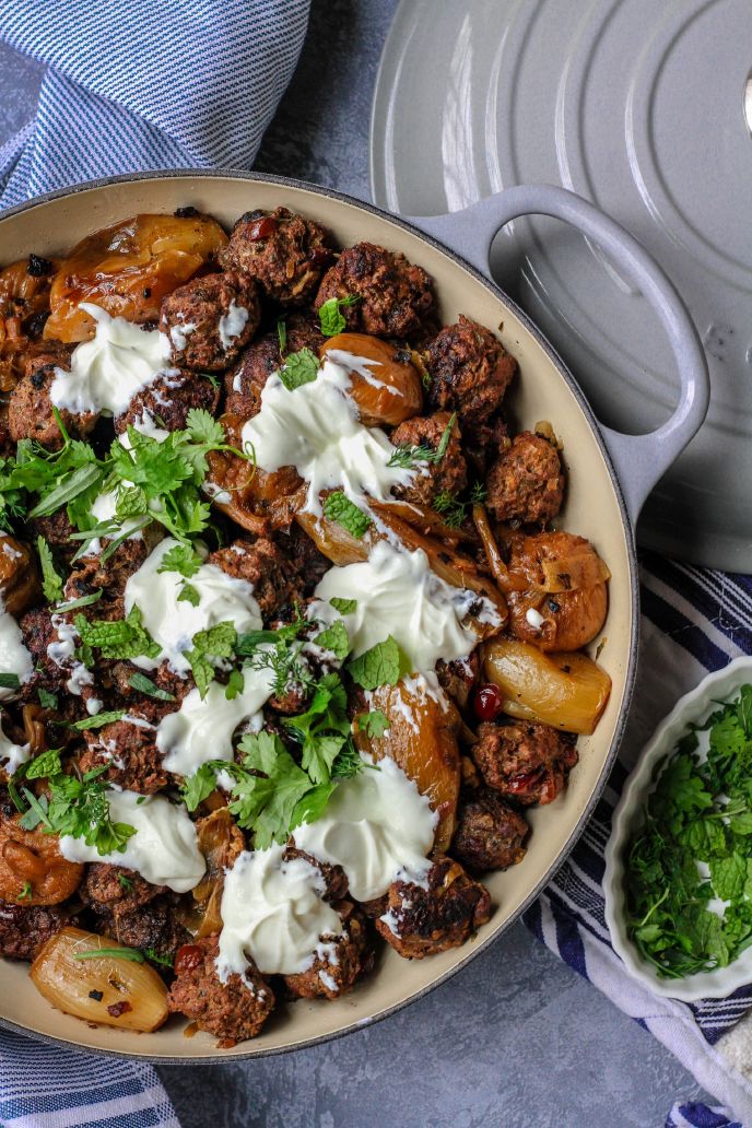 Gluten free meatballs in a skillet with onions and sour cream