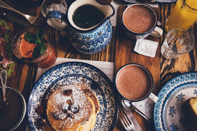 Tiramisu pancakes on a table with coffee