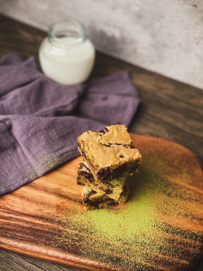 Vegan chickpea blondies stacked on a chopping board